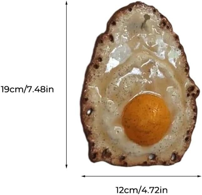 Fried egg hanging on a nail sculpture